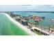An aerial view of a beachfront community featuring waterfront condos, boat docks, and white sand beaches at 1651 Sand Key Estates Ct # 54, Clearwater Beach, FL 33767