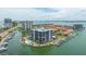 Aerial view of waterfront condo featuring boat slips, pool, and nearby townhomes at 1651 Sand Key Estates Ct # 54, Clearwater Beach, FL 33767