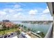 Scenic view of a waterfront community featuring numerous boat docks, palm trees, and luxurious residences at 1651 Sand Key Estates Ct # 54, Clearwater Beach, FL 33767
