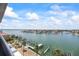 Breathtaking view from a balcony overlooking a serene harbor with multiple docks and waterfront properties at 1651 Sand Key Estates Ct # 54, Clearwater Beach, FL 33767