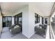 Spacious covered balcony features comfortable seating and views of the city skyline and waterfront at 1651 Sand Key Estates Ct # 54, Clearwater Beach, FL 33767