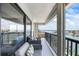 Wide balcony with comfortable seating offering stunning views of the bay, docks, and waterfront homes at 1651 Sand Key Estates Ct # 54, Clearwater Beach, FL 33767