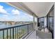 Extended balcony offering ample seating and panoramic views of the water, boats, and residential area at 1651 Sand Key Estates Ct # 54, Clearwater Beach, FL 33767