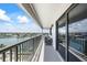 Covered balcony with gray furniture and stunning views of the waterfront and neighboring properties at 1651 Sand Key Estates Ct # 54, Clearwater Beach, FL 33767