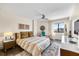 Comfortable bedroom boasts stylish decor, a ceiling fan, and plenty of natural light through a large window at 1651 Sand Key Estates Ct # 54, Clearwater Beach, FL 33767