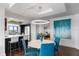 Contemporary dining area blending with the kitchen, featuring an island, stainless steel appliances, and chic design at 1651 Sand Key Estates Ct # 54, Clearwater Beach, FL 33767