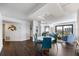 Bright dining area with modern light fixture, flowing into the living room, offering seamless entertaining space at 1651 Sand Key Estates Ct # 54, Clearwater Beach, FL 33767