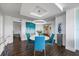 Contemporary dining room features a round table with blue chairs, a modern light fixture, and stylish decor at 1651 Sand Key Estates Ct # 54, Clearwater Beach, FL 33767