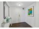 Entryway features wood floors, a glass table, and art, enhancing the stylish and inviting space at 1651 Sand Key Estates Ct # 54, Clearwater Beach, FL 33767