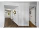 Bright hallway features wood floors, white walls with stylish decor, and doorways leading to other rooms at 1651 Sand Key Estates Ct # 54, Clearwater Beach, FL 33767