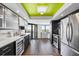 Contemporary kitchen with stainless steel appliances, dark cabinets, and a breakfast bar overlooking a scenic view at 1651 Sand Key Estates Ct # 54, Clearwater Beach, FL 33767