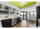Bright, modern kitchen with stainless steel appliances, sleek cabinetry, and a breakfast bar with scenic water views at 1651 Sand Key Estates Ct # 54, Clearwater Beach, FL 33767
