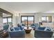 Stylish living room with comfortable seating, large mirror, and a sliding door to a spacious balcony overlooking the water at 1651 Sand Key Estates Ct # 54, Clearwater Beach, FL 33767