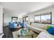 Bright living room with floor to ceiling windows, a white leather sofa, and modern decor at 1651 Sand Key Estates Ct # 54, Clearwater Beach, FL 33767