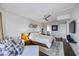 Comfortable bedroom with seating area, modern art, a ceiling fan, and ensuite bathroom at 1651 Sand Key Estates Ct # 54, Clearwater Beach, FL 33767