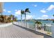 The deck provides stunning water views with palm trees and boats docked along the waterfront at 17077 Dolphin Dr, North Redington Beach, FL 33708