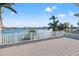 Large deck with white railing overlooking the water with views of the surrounding neighborhood at 17077 Dolphin Dr, North Redington Beach, FL 33708
