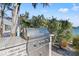 Modern outdoor kitchen featuring a stainless steel grill, brick accents, and serene waterfront views at 17077 Dolphin Dr, North Redington Beach, FL 33708