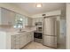 Efficient kitchen featuring stainless steel appliances, modern cabinetry, and plenty of light at 2020 Douglas Ave, Dunedin, FL 34698