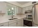 Well-lit kitchen area with modern countertops, stainless appliances, and grey cabinets at 2020 Douglas Ave, Dunedin, FL 34698