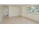 Bright, open living space showcasing terrazzo flooring, natural light, and freshly painted walls at 2020 Douglas Ave, Dunedin, FL 34698