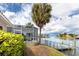 Waterfront backyard boasts a screened lanai, lush landscaping, and private dock with stunning water views at 2096 Massachusetts Ne Ave, St Petersburg, FL 33703