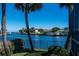 Scenic waterfront views from the backyard with lush greenery and mature palm trees, showing the canal at 2096 Massachusetts Ne Ave, St Petersburg, FL 33703