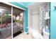 Bright bathroom features sliding glass door leading to a screened porch with waterfront views at 2096 Massachusetts Ne Ave, St Petersburg, FL 33703