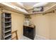 Walk-in closet features built-in shelving, hanging storage, and a small black cabinet at 2096 Massachusetts Ne Ave, St Petersburg, FL 33703