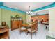 Cozy dining area features a round table with seating for four and adjacent sitting room at 2096 Massachusetts Ne Ave, St Petersburg, FL 33703