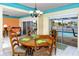Bright dining room features a wooden table and chairs with views of the pool and canal at 2096 Massachusetts Ne Ave, St Petersburg, FL 33703