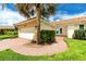 Charming home exterior featuring a brick walkway, well-maintained lawn, and a terra cotta tiled roof at 2096 Massachusetts Ne Ave, St Petersburg, FL 33703