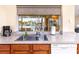 Kitchen sink with a large window offering views of the pool and canal at 2096 Massachusetts Ne Ave, St Petersburg, FL 33703