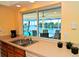 Kitchen sink with a large window offering views of the pool and canal at 2096 Massachusetts Ne Ave, St Petersburg, FL 33703
