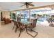 Enjoy the pool and water views from this shaded lanai with dining and lounge areas at 2096 Massachusetts Ne Ave, St Petersburg, FL 33703