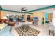 Spacious living area with tile flooring and bright decor offering views of the waterfront pool area at 2096 Massachusetts Ne Ave, St Petersburg, FL 33703