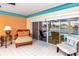 Relaxing sunroom with wicker furniture overlooking the pool and canal, offering a peaceful retreat at 2096 Massachusetts Ne Ave, St Petersburg, FL 33703