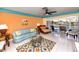 Comfortable living room with tile floors, large windows showcasing the pool and canal views at 2096 Massachusetts Ne Ave, St Petersburg, FL 33703