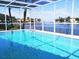 Sparkling pool within a screened enclosure offers serene waterfront views and a refreshing outdoor experience at 2096 Massachusetts Ne Ave, St Petersburg, FL 33703