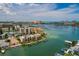 Aerial view of a waterfront condo complex with docks, boatlifts and city views on a sunny day at 222 Skiff Pt, Clearwater, FL 33767