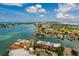 Beautiful aerial view of a red-roofed townhome community on the water with boat docks in a sunny coastal location at 222 Skiff Pt, Clearwater, FL 33767