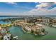 Expansive aerial view showcasing a waterfront community with boat docks, lush landscaping, and city skyline in the distance at 222 Skiff Pt, Clearwater, FL 33767