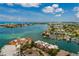 Aerial view of waterfront property, docks, boats, and a city skyline with blue skies and sunshine at 222 Skiff Pt, Clearwater, FL 33767