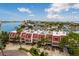 Aerial view of a townhouse complex with red roofs, waterfront access, and stunning neighborhood views at 222 Skiff Pt, Clearwater, FL 33767
