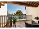 Relaxing balcony with outdoor seating overlooking the water and lush tropical landscaping at 222 Skiff Pt, Clearwater, FL 33767
