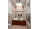 Bathroom with a tub in a tiled enclosure and illuminated by a skylight at 222 Skiff Pt, Clearwater, FL 33767