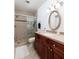 Bathroom featuring a glass shower and a dark wood vanity with an oval mirror at 222 Skiff Pt, Clearwater, FL 33767