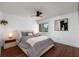 Cozy bedroom with a comfortable bed, modern ceiling fan, and dark hardwood floors at 222 Skiff Pt, Clearwater, FL 33767