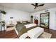 Comfortable bedroom with a ceiling fan, bench seating, bedside tables and a mirror at 222 Skiff Pt, Clearwater, FL 33767