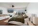 Spacious bedroom featuring water views from the balcony, a comfortable bed, and modern fan at 222 Skiff Pt, Clearwater, FL 33767